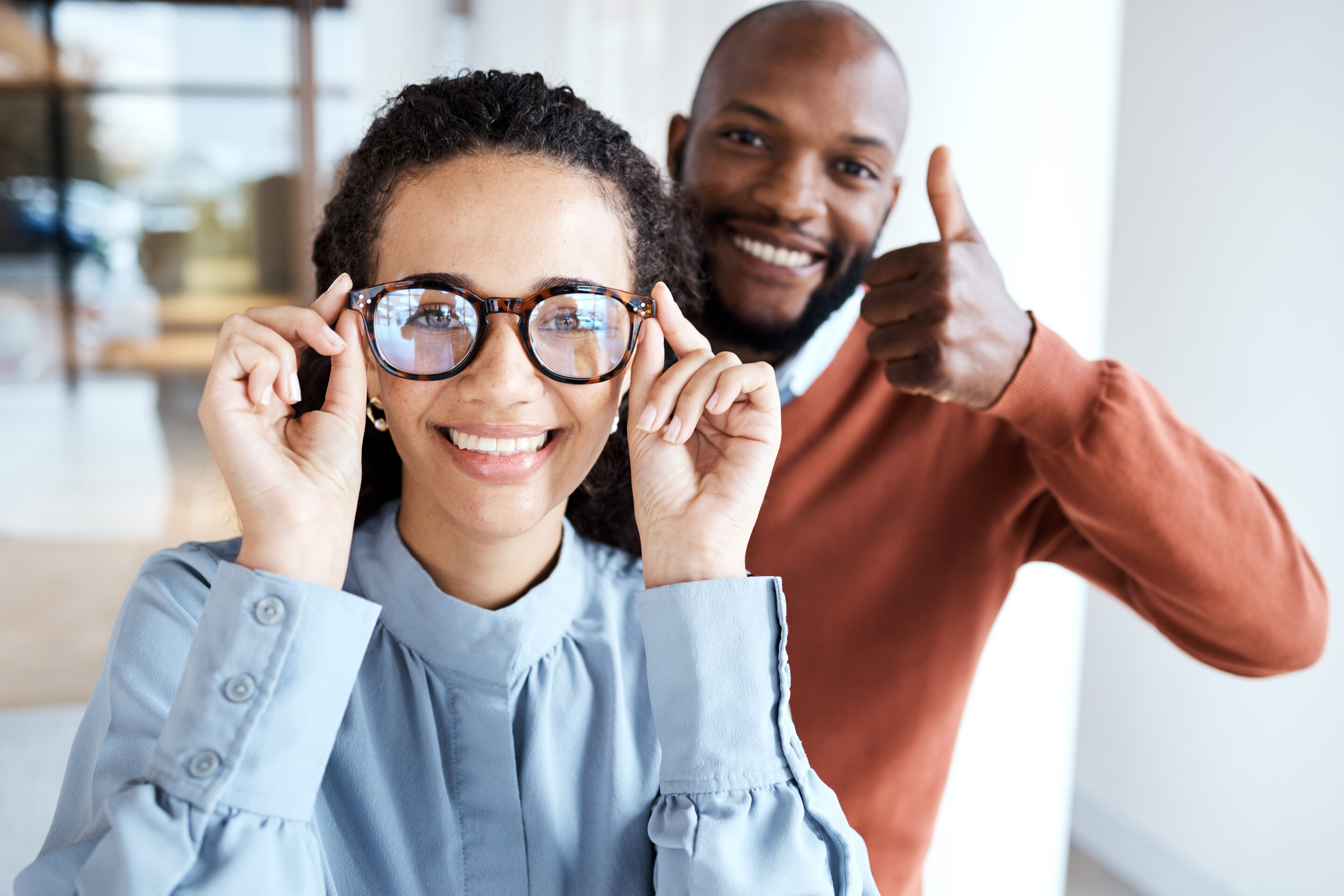 glasses, portrait and woman with a thumbs up from an optician for the choice of frame in a store. yes, agreement and girl with eyeglasses from a black man giving vision service with a hand sign glasses, portrait and woman with a thumbs up from an optician for the choice of frame in a store. yes, agreement and girl with eyeglasses from a black man giving vision service with a hand sign